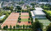 vue aérienne du site du Sporting au coeur de la ville de Vichy. Piscine extérieur à gauche, 6 terrains de tennis en terre battue extérieurs, 6 postes de padel en herbe en extérieur et deux bâtiments